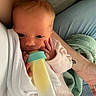 Marcellina is registered to the contest to win money with this photo: baby, infant, bottle, feeding, hand, arm, blanket, clothing, person, newborn, face, skin, comfort, resting, indoor, closeup, cute, young, sleepy, care