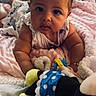 baby, infant, child, portrait, face, eyes, looking_at_camera, indoors, bed, blanket, pink_blanket, stuffed_toy, mickey_mouse, toy, sitting, lying_down, baby_clothing, cozy, home, close_up