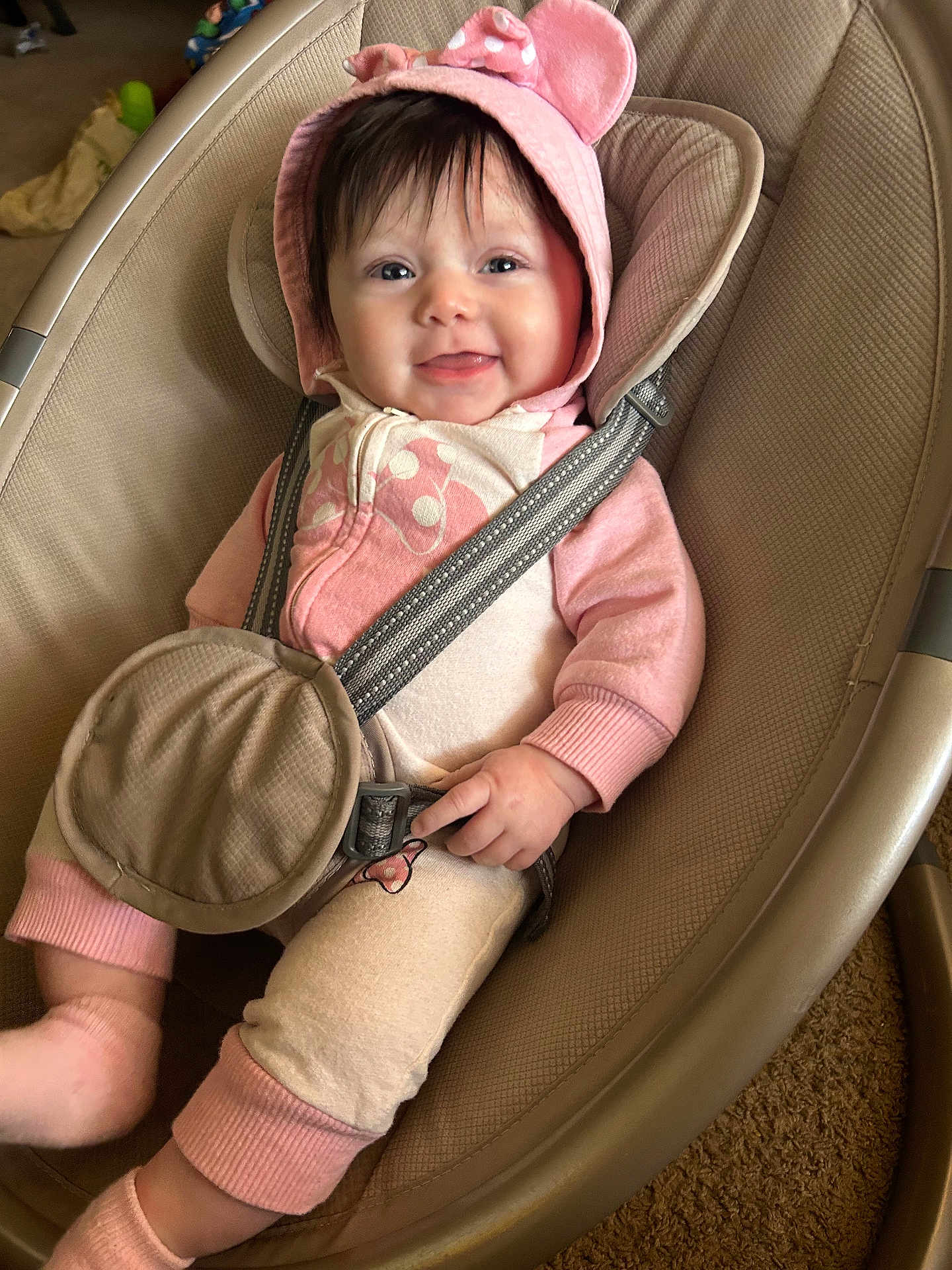 Nayeli is registered to the contest to win money with this photo: baby, child, smiling, hood, pink_clothing, onesie, baby_seat, safety_strap, indoor, carpet, cute, infant, happy, person, face, seatbelt, apparel, baby_accessory, cozy, portrait