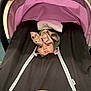 Nayeli is registered to the contest to win money with this photo: baby, stroller, pink_canopy, cozy_cover, bow, face, child, infant, clothing, zipper, baby_cover, headwear, indoors, portrait, cute, seated, looking_up, bundle, warm, expression