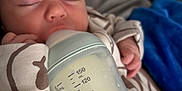 Leo joined the competition — help win amazing prizes! baby, blanket, bottle, closed_eyes, couch, cozy, cute, face, feeding, hand, indoors, infant, milk, newborn, onesie, peaceful, person, resting, sleeping, soft_fabric