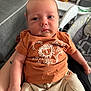 Leo joined the competition — help win amazing prizes! baby, child, clothing, comfort, couch, cute, expression, face, hand, human, indoor, infant, lion_design, living_room, orange_tshirt, pants, person, relaxing, sitting, young