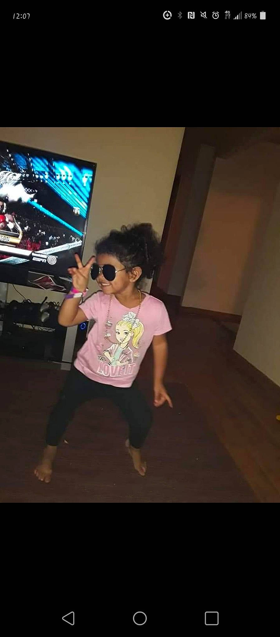 Amina joined the competition — help win amazing prizes! display_device, entertainment, event, eyewear, fashion_design, flash_photography, flooring, fun, gadget, leisure, magenta, performing_arts, person, room, shorts, sportswear, standing, sunglasses, t_shirt, television