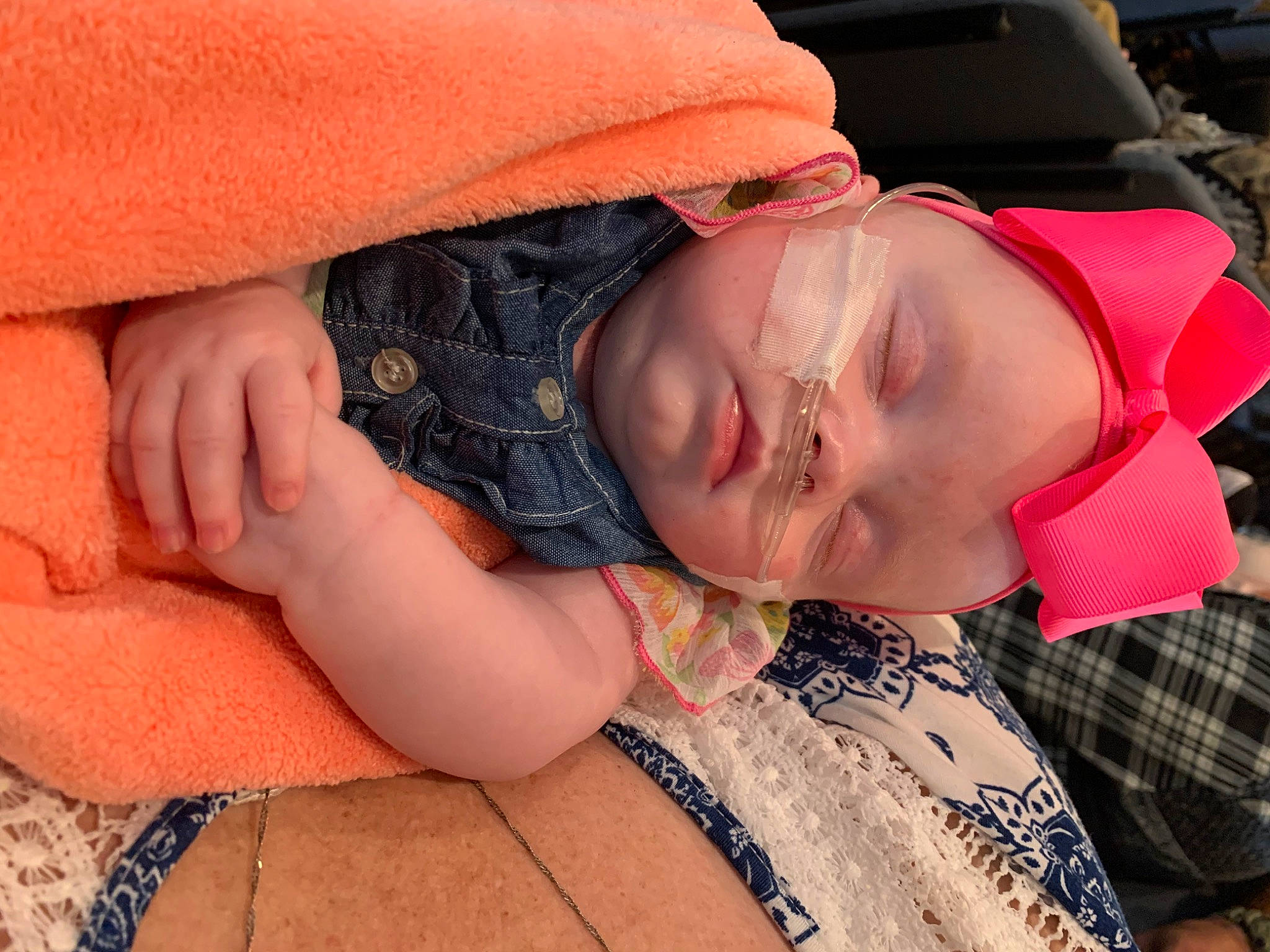 Maggie is registered to the contest to win money with this photo: arm, child, comfort, elbow, eye, eyelash, glasses, head, joint, lip, mouth, neck, nose, orange, person, shoulder, skin, sleeve, tree, trunk