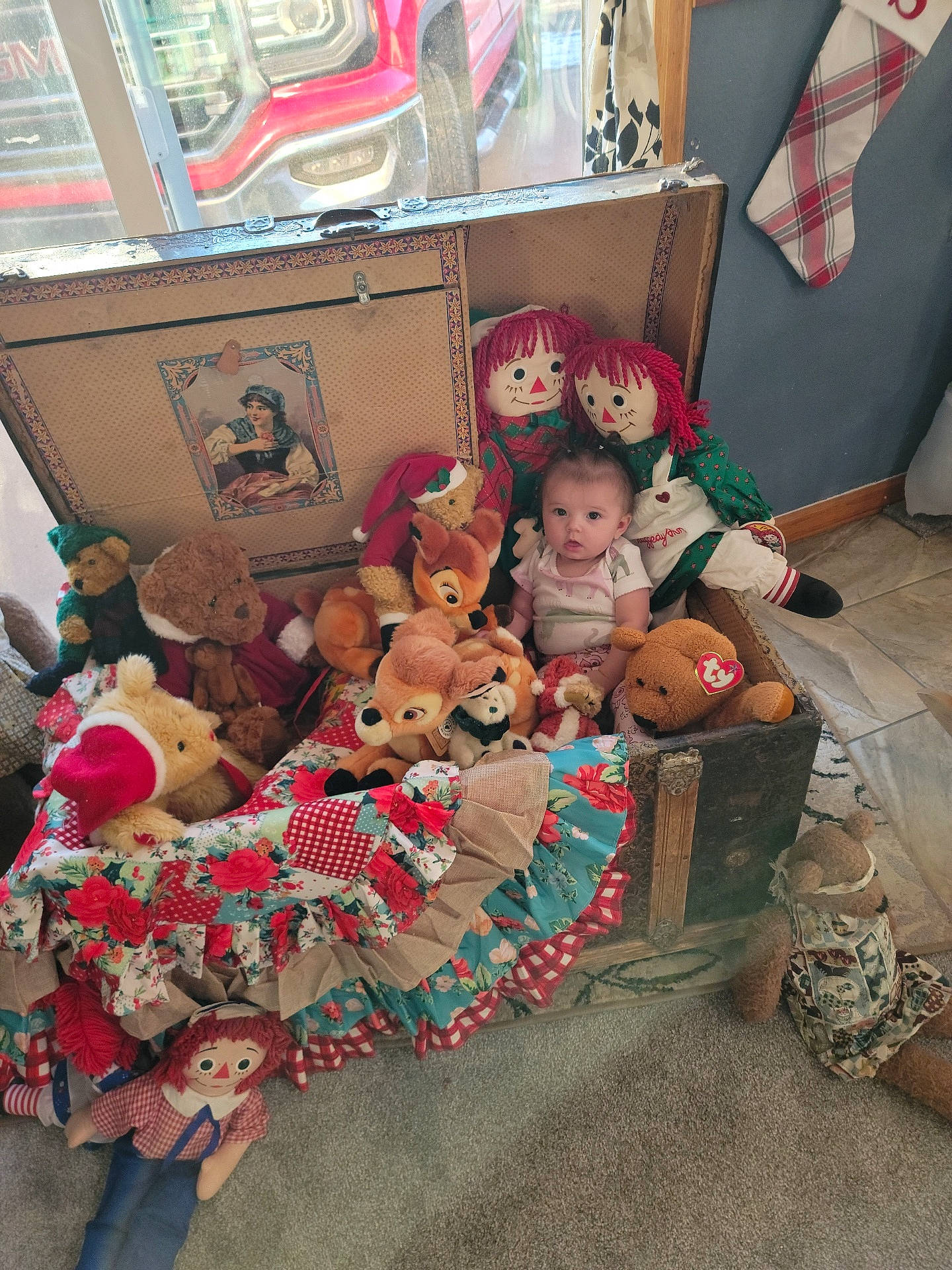 Fallon is registered to the contest to win money with this photo: carmine, child, christmas, christmas_decoration, christmas_eve, doll, event, flooring, fun, holiday, interior_design, lap, mammal, person, plush, room, stuffed_toy, teddy_bear, toy, tree