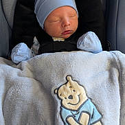 Liam is registered to the contest to win money with this photo: baby, blanket, blue_hat, car_seat, child, clothing, comfort, cozy, cute, indoors, infant, mittens, newborn, portrait, resting, sleeping, smile, soft, toddler, winnie_the_pooh