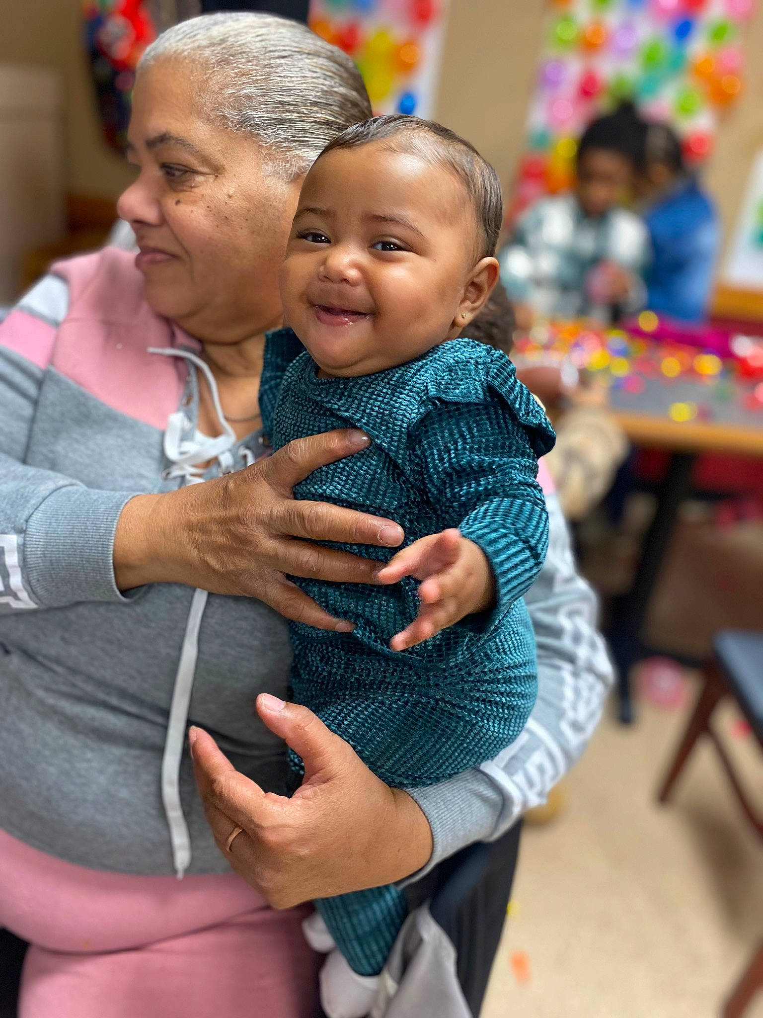 Naiomi is registered to the contest to win money with this photo: baby, chair, child, event, eye, fun, gesture, hand, happy, hug, jewellery, joy, leisure, people, person, product, sitting, skin, smile, toddler
