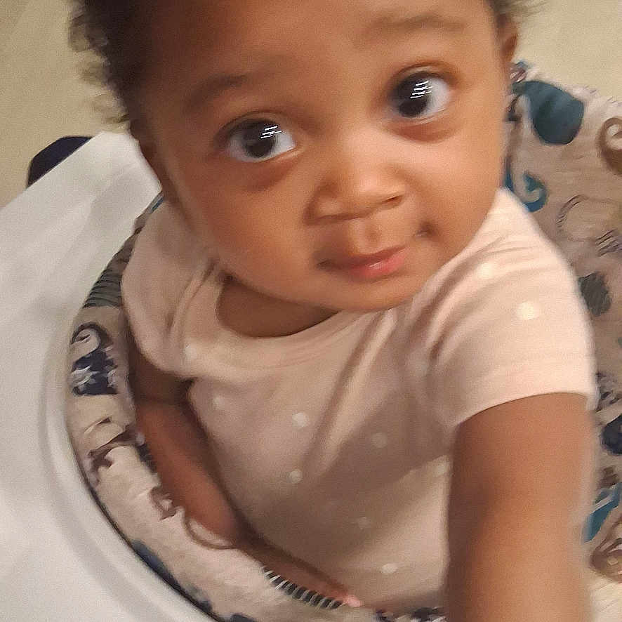 Shamarr joined the competition — help win amazing prizes! baby, car, child, clothing, curly_hair, cute, eyes, face, floor, indoor, infant, person, play, polka_dot, reaching, seat, toy, walker, white_car, young_child