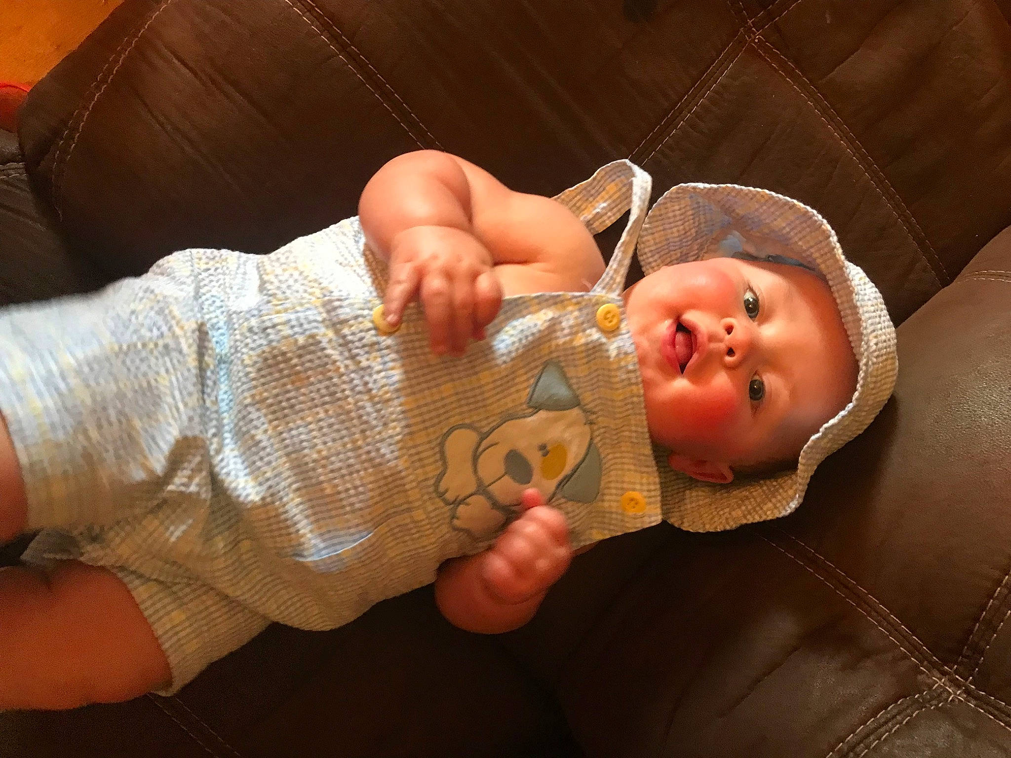 Kylan is registered to the contest to win money with this photo: baby, baby_toddler_clothing, cheek, child, comfort, elbow, eye, finger, hand, happy, hat, head, headwear, human_body, mouth, nose, person, skin, smile, toddler