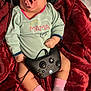 baby, blanket, clothing, cushion, electronics, face, furniture, head, headphones, homedecor, hosiery, person, photography, portrait, shorts, sitting, sock, t_shirt, yawning