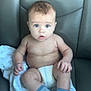 baby, infant, diaper, socks, striped_socks, blanket, chair, leather, seated, wide_eyes, surprised, child, person, skin, cute, indoor, portrait, young, baby_boy, expression