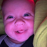 Paxton joined the competition — help win amazing prizes! baby, closeup, face, smile, tongue, eyes, infant, clothing, nike, blanket, yellow, pink_light, happy, cute, child, portrait, indoors, young, expression, cozy