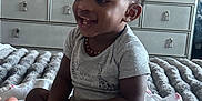 Vincent joined the competition — help win amazing prizes! toddler, child, smiling, bed, blanket, dresser, basket, hand, room, television, clothing, furniture, indoor, person, happy, curly_hair, sitting, baby, home, cozy