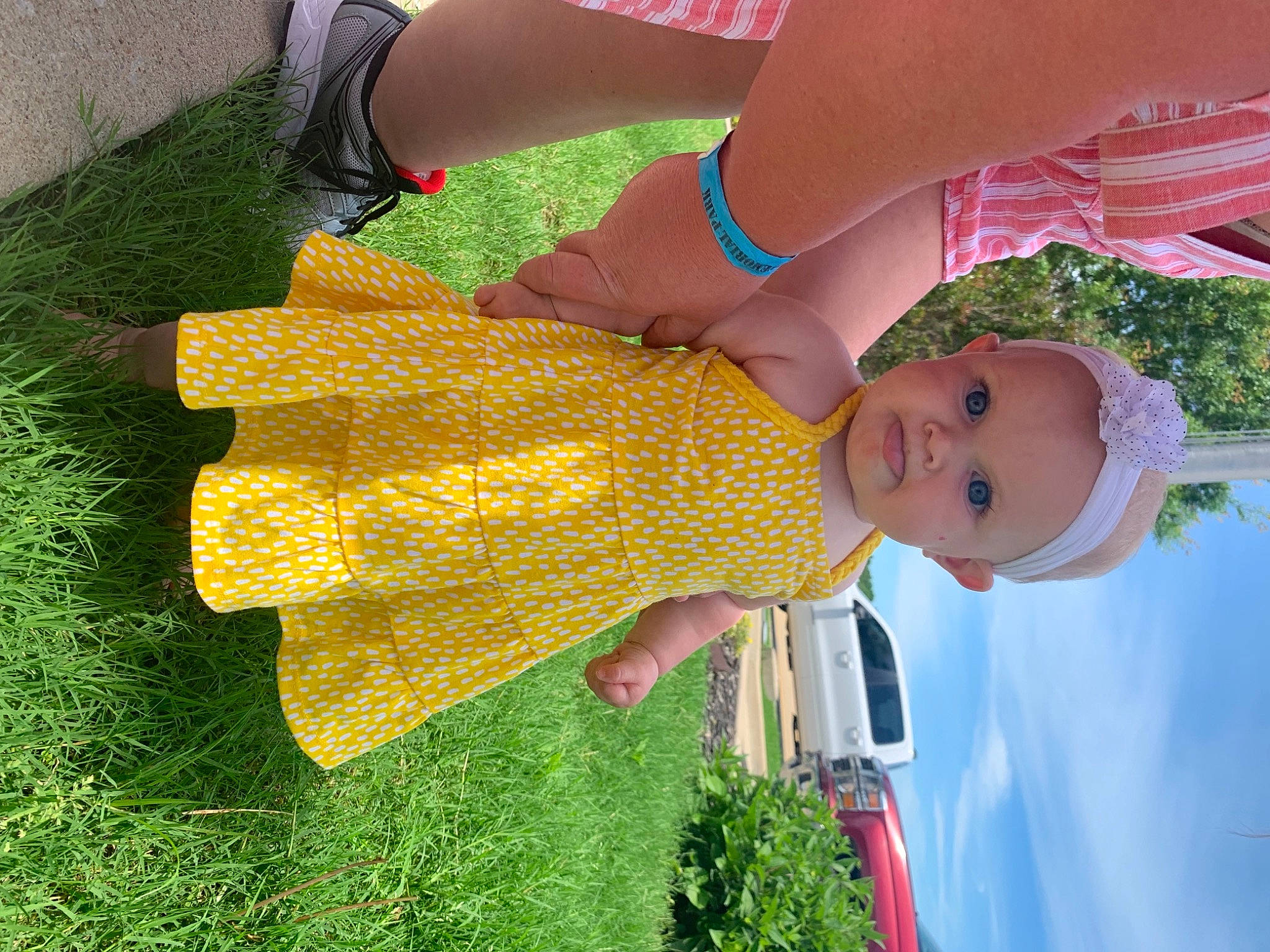 Jazmine joined the competition — help win amazing prizes! baby_toddler_clothing, dress, finger, fun, gesture, grass, green, hand, happy, hat, headwear, human_body, light, orange, people_in_nature, person, plant, red, sky, smile