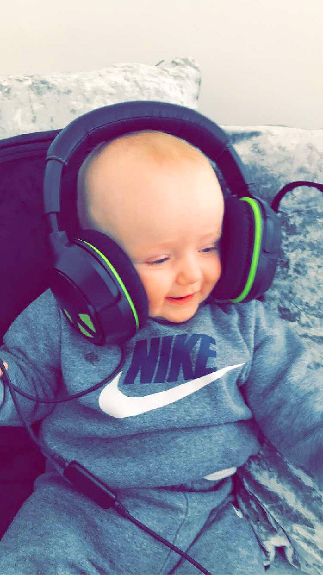 Arlo Jae is registered to the contest to win money with this photo: audio_equipment, baby, baby_toddler_clothing, cheek, child, comfort, cool, ear, electric_blue, electronic_device, fun, gadget, happy, head, headphones, person, personal_protective_equipment, purple, smile, snow