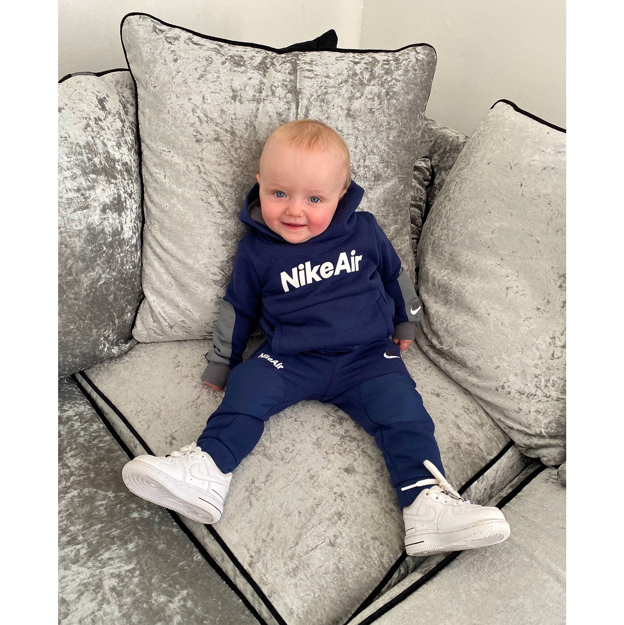 Arlo Jae is registered to the contest to win money with this photo: baby, baby_toddler_clothing, child, comfort, elbow, foot, head, human_leg, joy, knee, lap, linens, person, pillow, product, rectangle, shoe, sleeve, smile, t_shirt