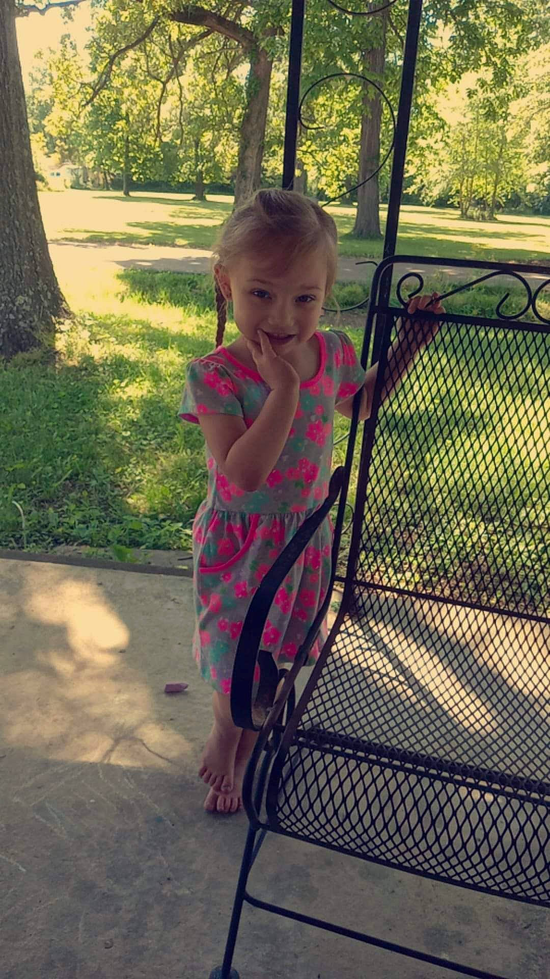 Emmalee is registered to the contest to win money with this photo: arm, baby_toddler_clothing, dress, eye, face, grass, hair, hand, happy, head, human_body, joy, leg, leisure, people_in_nature, person, plant, public_space, smile, sunlight