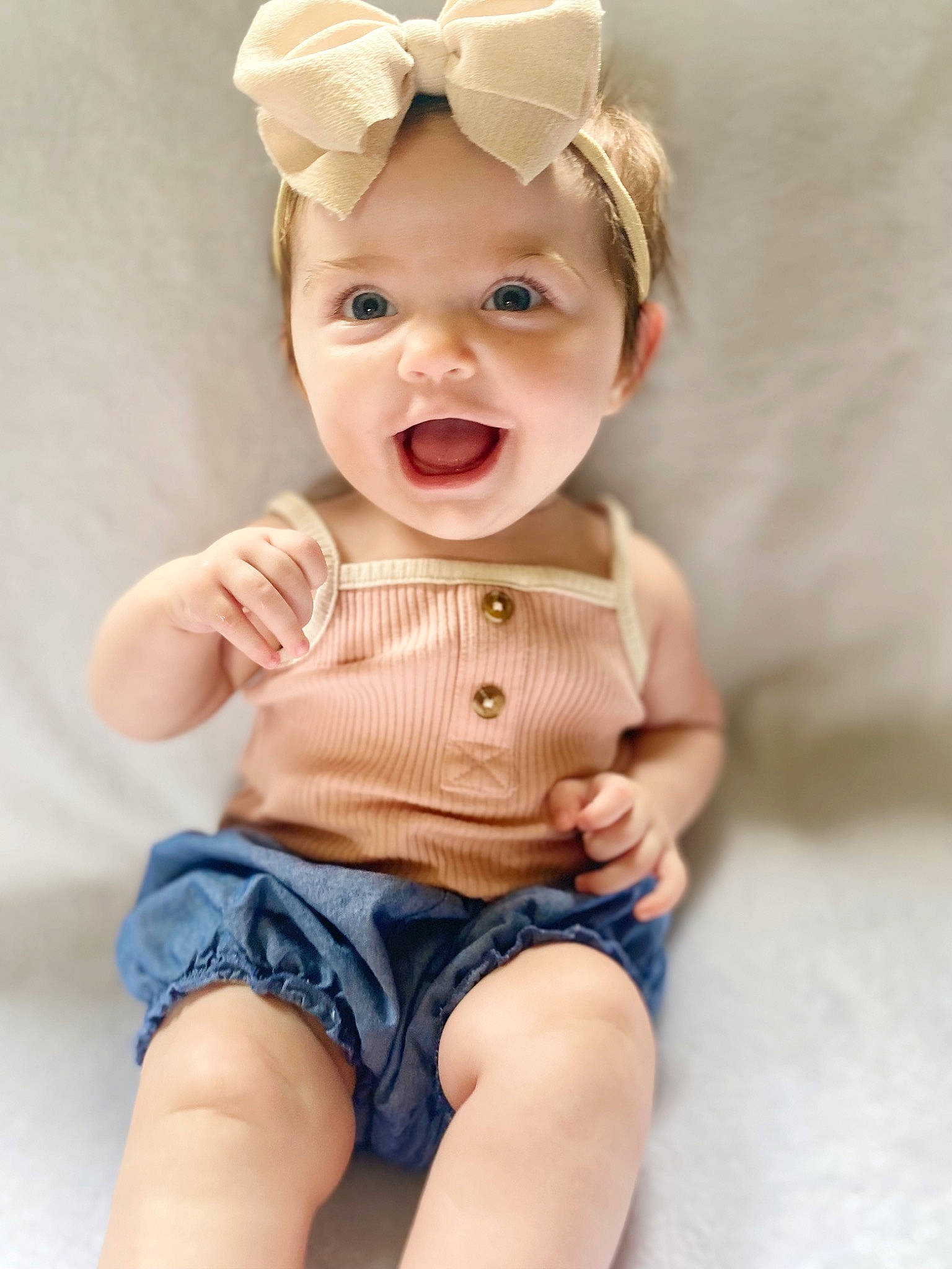 Kinsley is registered to the contest to win money with this photo: arm, baby, baby_toddler_clothing, eyelash, facial_expression, finger, hand, happy, headwear, neck, pattern, person, pink, shorts, skin, sleeve, smile, textile, thigh, toddler