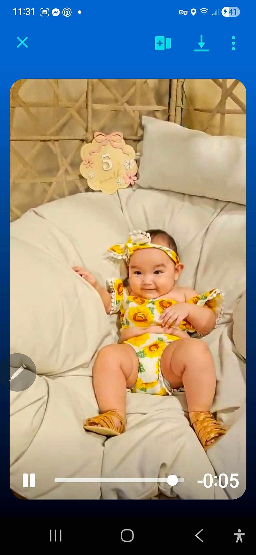 Nya Salyn Cook is registered to the contest to win money with this photo: baby, child, cozy, cushion, happy, headband, indoors, infant, legs, milestone_sign, number_5, outfit, pillow, playback_bar, portrait, sandals, seat, smile, sunflower_print, video_screenshot