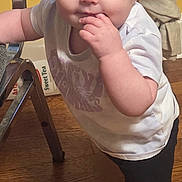 Elliana joined the competition — help win amazing prizes! baby, child, headband, blue_eyes, white_shirt, black_pants, white_shoes, indoor, wooden_floor, chair, curtains, floor, hand, standing, person, face, young_child, home, candid, cute
