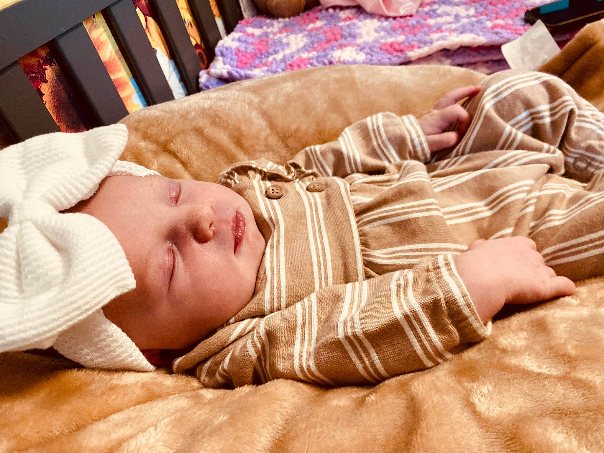 Briella is registered to the contest to win money with this photo: baby, baby_toddler_clothing, bedding, bedtime, child, comfort, couch, elbow, finger, flooring, hardwood, headwear, human_leg, linens, person, room, skin, sleeve, thigh, toddler