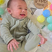 Aiden joined the competition — help win amazing prizes! baby, infant, smiling, play_mat, balloons, green_outfit, hands, feet, happy, cute, child, lying_down, colorful, soft_texture, indoor, young, five_months, cheerful, face, tongue_out