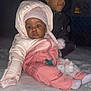 Damira is registered to the contest to win money with this photo: baby, child, snow, winter, snowsuit, pink_clothing, hat, pacifier, outdoor, cold_weather, face, person, sitting, cute, warm_clothing, night, smile, jacket, gloves, family