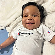 Kaizen joined the competition — help win amazing prizes! baby, smiling, cheerful, onesie, white_clothing, blanket, soft_texture, indoor, portrait, child, cute, happy, infant, face, head, resting, comfortable, person, young_child, casual