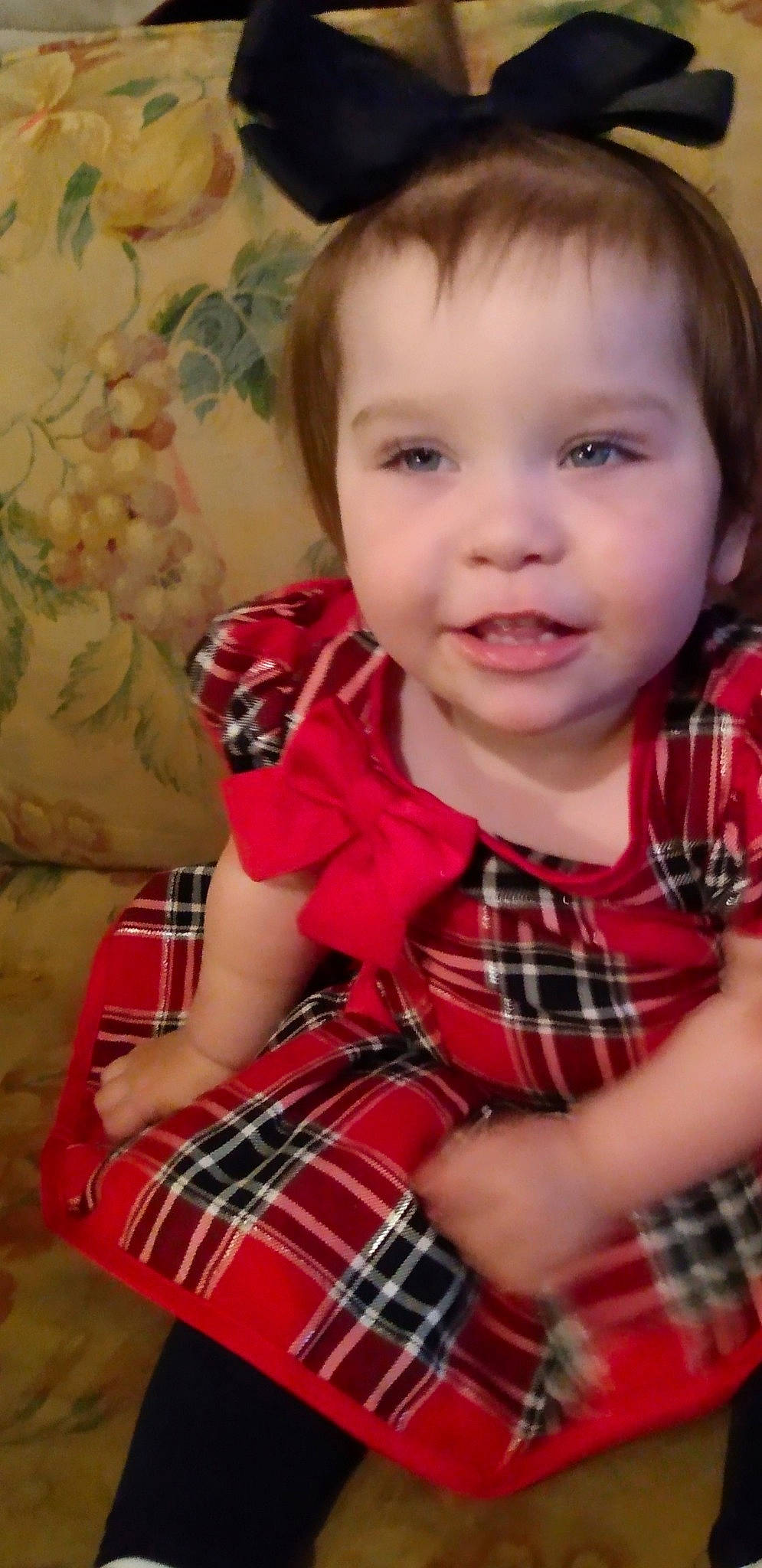 Gracie is registered to the contest to win money with this photo: baby, baby_toddler_clothing, cheek, child, collar, finger, happy, iris, lip, nose, pattern, person, plaid, red, sitting, skin, sleeve, smile, tartan, textile