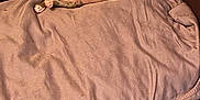 Franklin is registered to the contest to win money with this photo: puppy, dog, bed, cushion, indoor, relaxed, small_dog, brown, white, spotted, floor, wooden_floor, pet, cozy, resting, lying_down, fur, animal, cute, companion
