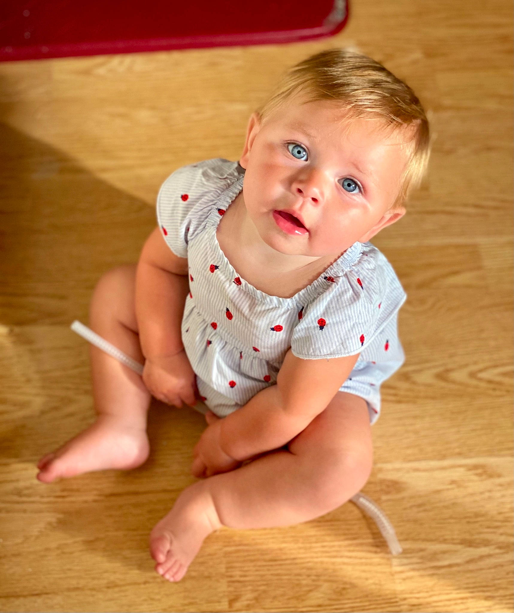 Sawyer is registered to the contest to win money with this photo: baby_toddler_clothing, barefoot, cheek, chest, elbow, floor, flooring, foot, hardwood, head, human_leg, knee, leg, neck, person, shorts, skin, sleeve, thigh, toddler