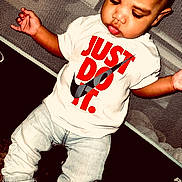 Raydon joined the competition — help win amazing prizes! toddler, child, baby, jeans, tshirt, slogan, text, footwear, mesh_background, indoor, fashion, casual_wear, person, closeup, expression, young_child, sitting, looking_down, hands, shoes