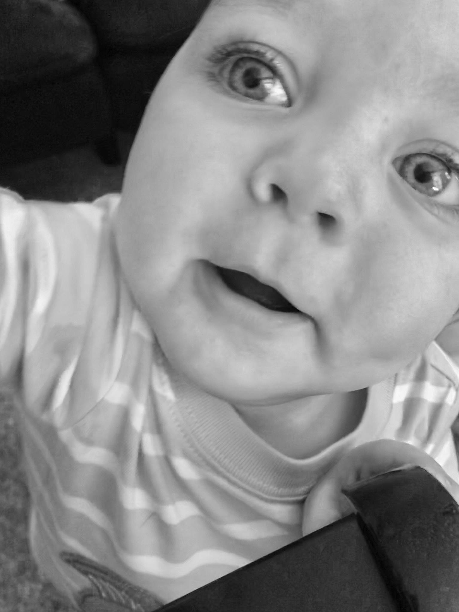 Noah James is registered to the contest to win money with this photo: black, black_and_white, cheek, child, chin, emotion, eye, eyebrow, face, facial_expression, head, infant, lip, monochrome_photography, nose, person, photograph, skin, smile, white