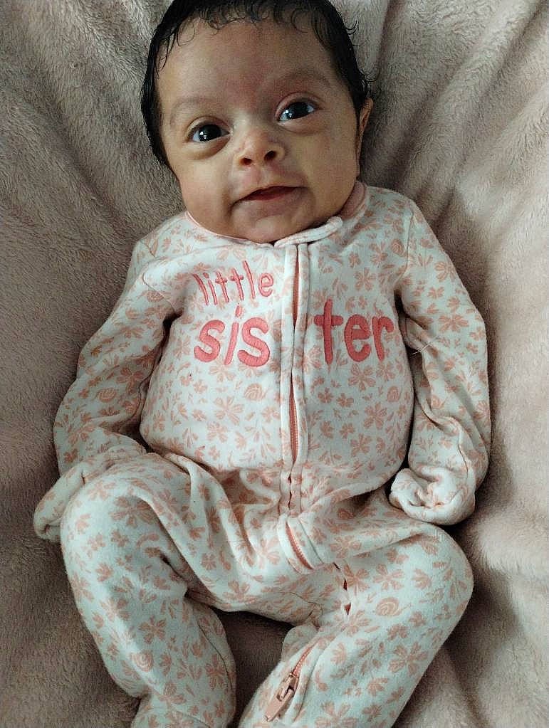 baby, babylaughing, clothing, face, fleece, happy, head, newborn, pajamas, pants, person, photography, portrait, quilt, sitting, sleeve, smile