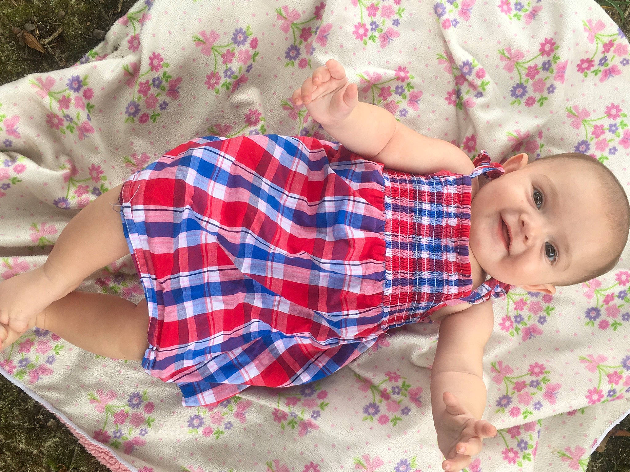 Mazie joined the competition — help win amazing prizes! arm, baby, baby_toddler_clothing, child, comfort, dress, grass, hand, joy, linens, pattern, person, pink, plaid, product, skin, sleeve, smile, t_shirt, tartan