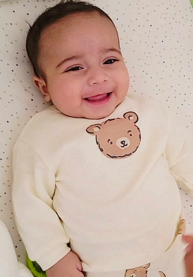 Yanis a rejoint le concours — aidez-le/la à gagner de superbes lots ! baby, smiling, infant, clothing, bear_design, blanket, cute, happy, lying_down, child, portrait, face, cozy, indoor, soft, young, sleeves, pattern, person, adorable