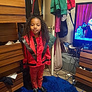 Royall joined the competition — help win amazing prizes! black_shoes, blue_rug, cables, casual, child, clothing, curly_hair, door, floor, furniture, hanger, indoor, person, portrait, red_jacket, room, smiling, standing, television, wooden_drawers