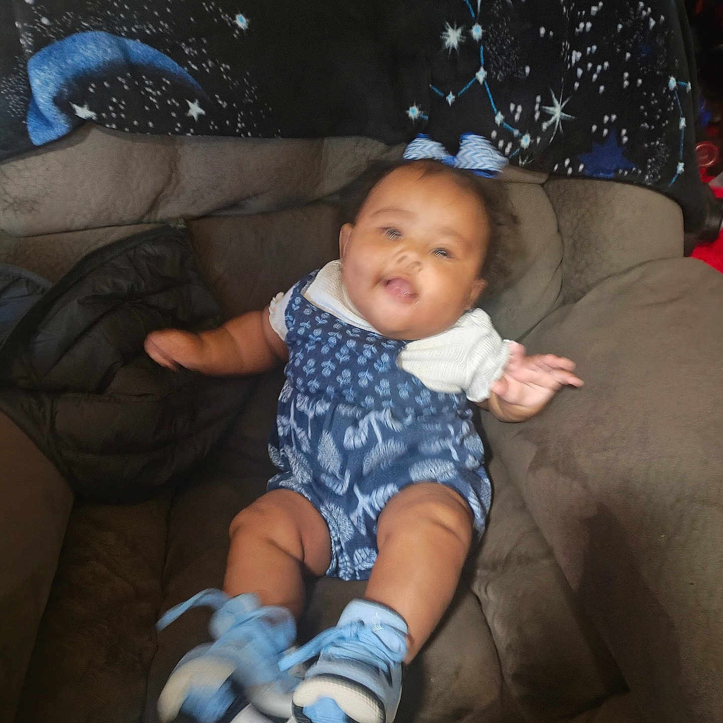Amria joined the competition — help win amazing prizes! armchair, baby, blanket, blue_bow, blue_outfit, candid, child, constellation_pattern, cozy, cute, furniture, happy, home, indoor, infant, motion_blur, person, seated, smiling, sneakers