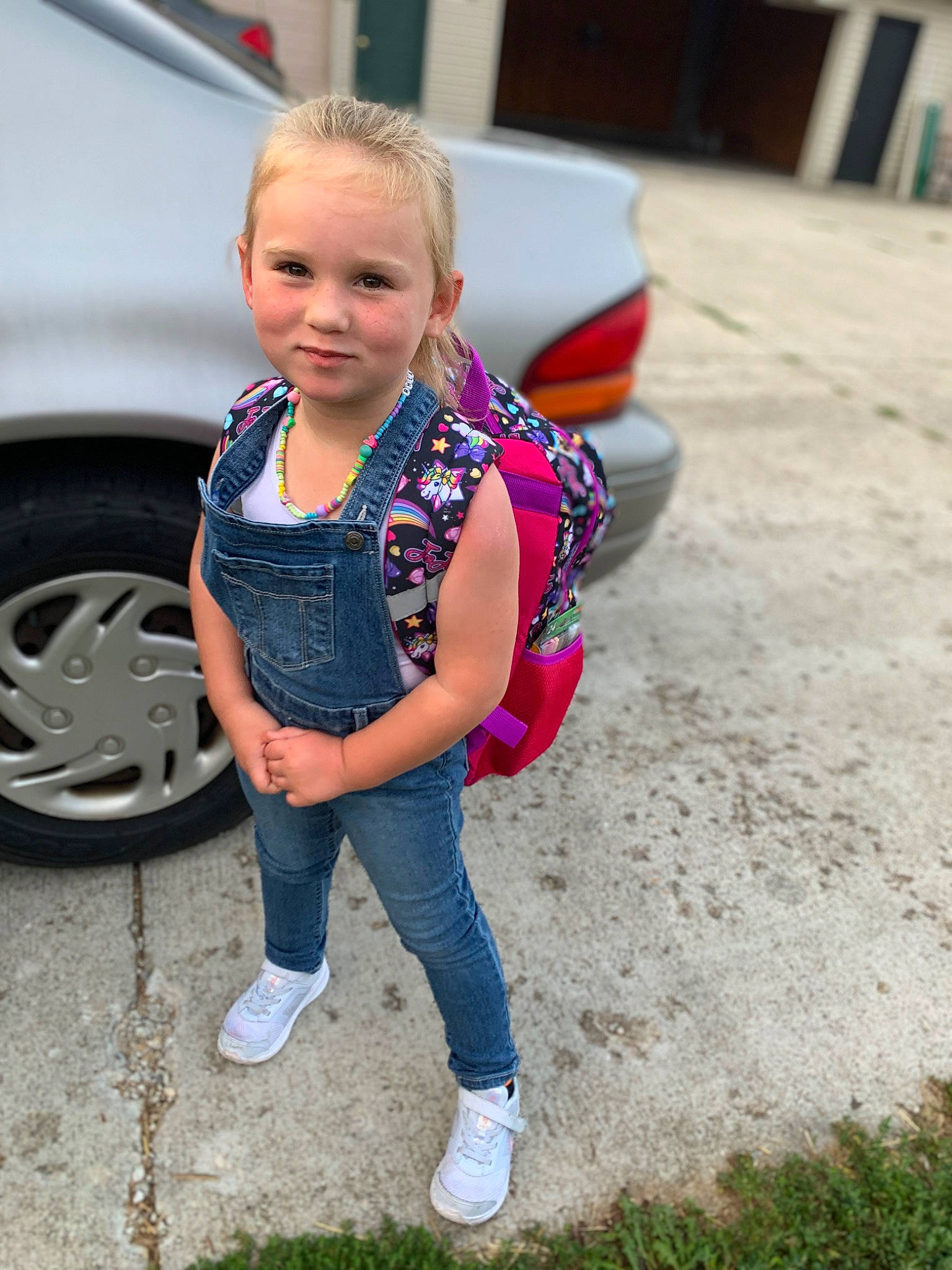 Rheah is registered to the contest to win money with this photo: alloy_wheel, asphalt, automotive_exterior, automotive_lighting, automotive_tire, bumper, car, hair, hood, jeans, joy, motor_vehicle, person, rim, sneakers, street_fashion, tire, toddler, vehicle, vehicle_door