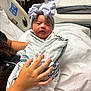 Kennedy is registered to the contest to win money with this photo: newborn, baby, hospital, blanket, bow, hat, person, hand, bed, medical, wristband, swaddle, infant, cute, indoor, healthcare, patient, rest, comfort, nursery