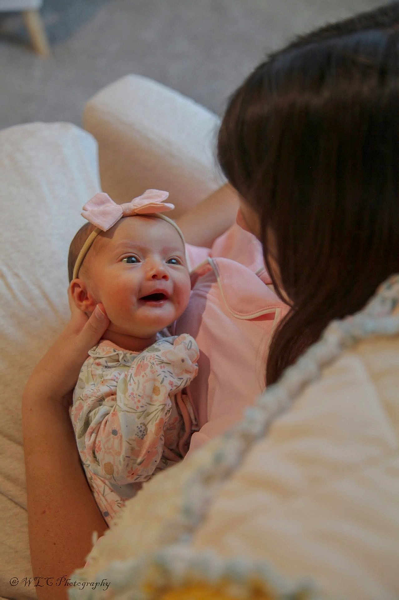 Kennedy joined the competition — help win amazing prizes! adult, baby, bow, care, child, closeup, cozy, family, floral_clothing, happy, headband, holding, indoor, infant, love, parent, portrait, smile, tenderness, woman