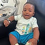 Ebrahim is registered to the contest to win money with this photo: architecture, baby, babylaughing, clothing, couch, cushion, face, footwear, furniture, happy, head, homedecor, person, photography, portrait, shoe, shorts, sitting, smile, t_shirt