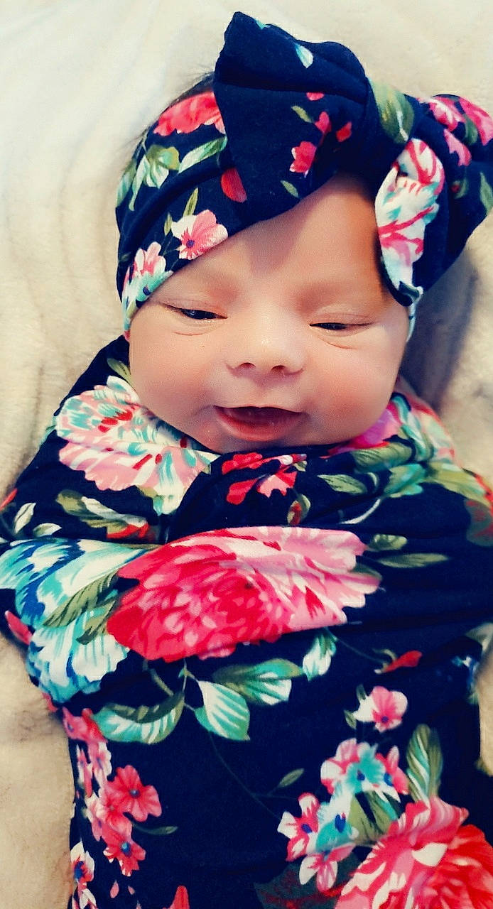 Penelope Joliee Mier is registered to the contest to win money with this photo: baby, baby_products, cheek, child, dress, head, headgear, headwear, person, plant, smile, textile, toddler