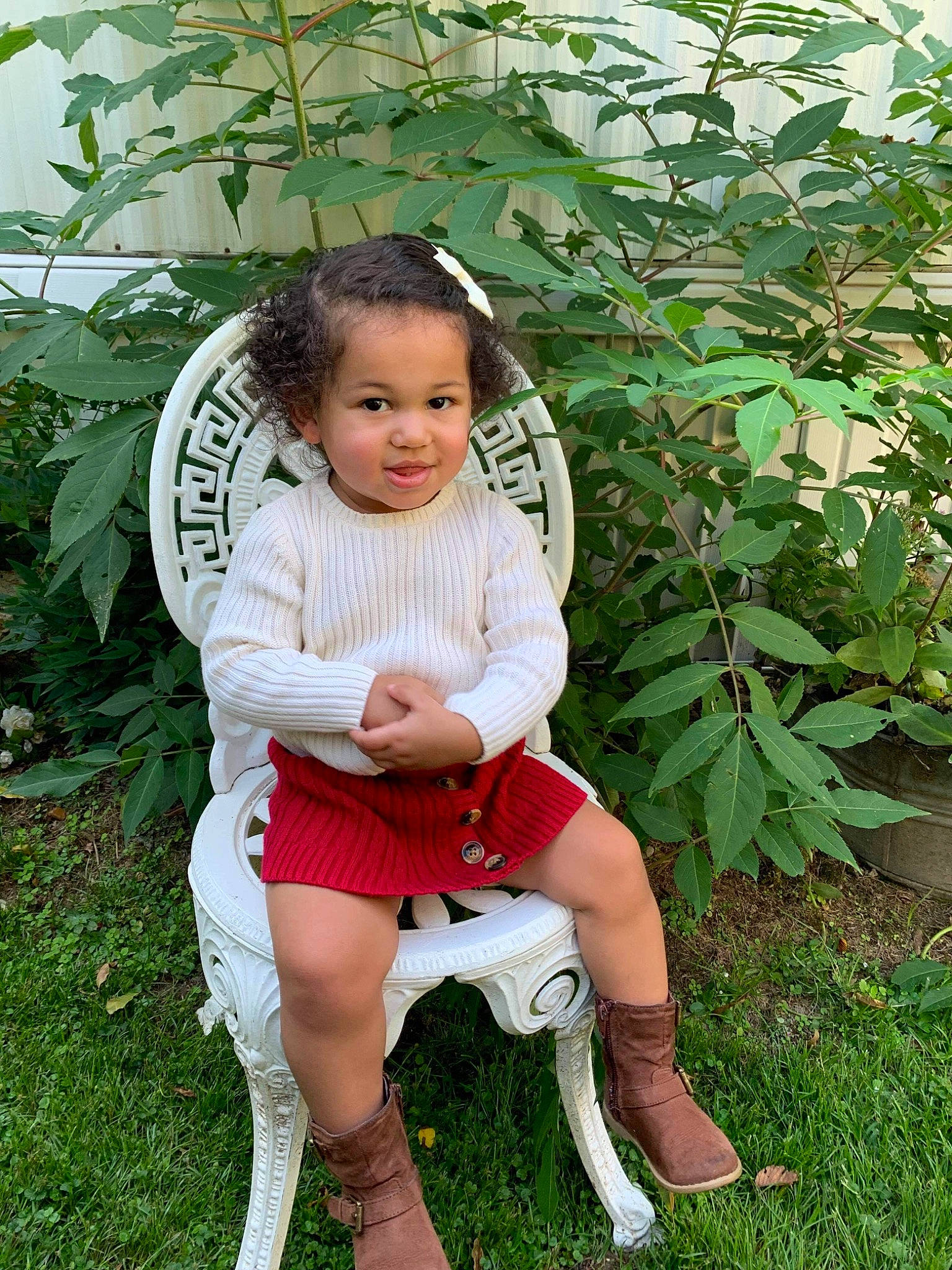 Madisynn is registered to the contest to win money with this photo: black_hair, botany, child, clothing, garden, grass, grass_family, hairstyle, human_leg, jewellery, long_hair, pattern, people_in_nature, person, plant, shoe, sitting, skin, sleeve, thigh