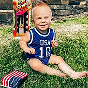 Lager Dean is registered to the contest to win money with this photo: toddler, child, grass, lawn, blue_jersey, usa, number_10, flag, american_flag, fireworks, box, mohawk, smiling, sunny, outdoor, summer, happy, barefoot, playing, portrait