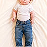 baby, infant, child, blue_eyes, curly_hair, onesie, denim_jeans, rolled_up_jeans, bare_feet, lying_down, blanket, soft_texture, portrait, cute, adorable, indoor, casual_clothing, young, curious, baby_pose