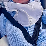 Jaxon is registered to the contest to win money with this photo: baby, sleeping, blue_hat, knitwear, car_seat, baby_bib, baby_clothing, infant, peaceful, child, cute, pom_poms, blanket, seatbelt, portrait, face, young_child, indoors, soft_texture, cozy