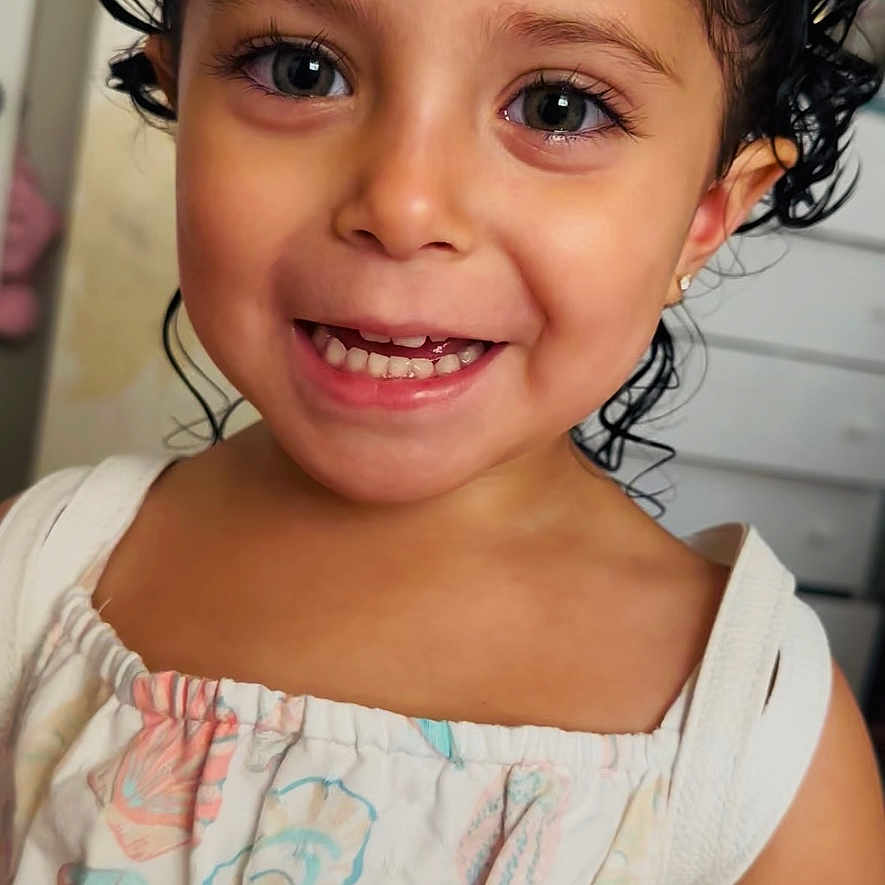 Sarabella is registered to the contest to win money with this photo: bow, child, childhood, clothing, curly_hair, cute, dress, eyes, face, fashion, girl, hair, happy, indoor, person, portrait, skin, smile, toddler, young