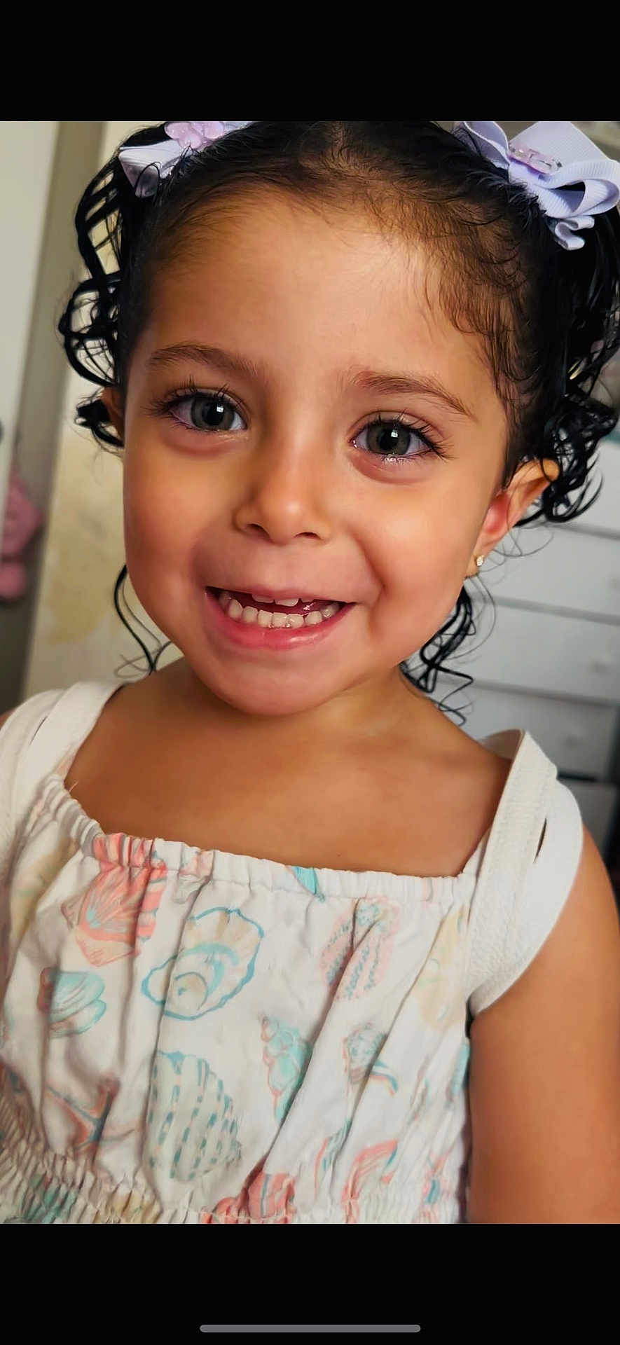 Sarabella is registered to the contest to win money with this photo: child, toddler, smile, curly_hair, dress, indoor, happy, girl, portrait, face, bow, clothing, cute, person, skin, eyes, young, fashion, hair, childhood