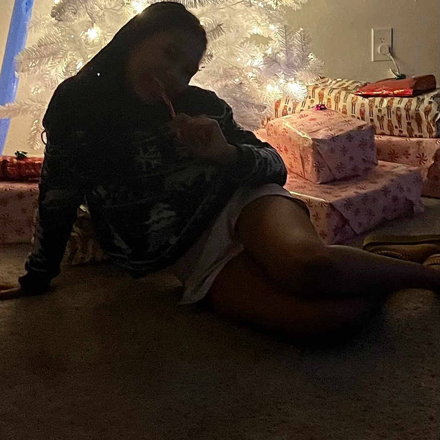 Skyler is registered to the contest to win money with this photo: candy_cane, carpet, celebration, christmas_tree, dark, decorations, festive, gift_wrapping, holiday, indoor, lights, ornaments, outlet, person, presents, relaxing, shadow, sitting, wall, winter